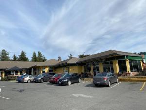 a parking lot with cars parked in front of a store at Adorable 2-bedroom guesthouse with free parking in Victoria