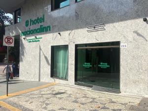 a building with a glass door on a street at Hotel Nacional Inn Belo Horizonte in Belo Horizonte