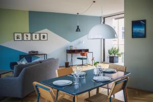 a dining room with a blue table and chairs at The Circus Apartments in Berlin