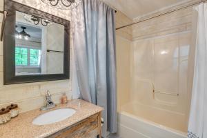 a bathroom with a sink and a shower and a mirror at Cozy Tennessee Retreat with Patio and Charcoal Grill! in Linden +17 photos