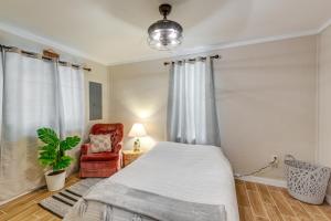 a bedroom with a bed and a chair at Cozy Tennessee Retreat with Patio and Charcoal Grill! in Linden