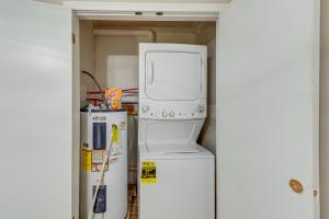 a microwave oven sitting on top of a refrigerator at Cozy Tennessee Retreat with Patio and Charcoal Grill! in Linden