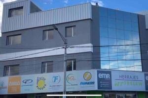 a building with signs on the side of it at Apart Trelew 7 in Trelew