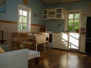 a kitchen with a table and chairs in a room at Backyard Village in Hveragerði