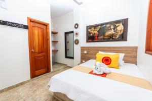 a bedroom with two beds and a wooden door at Hotel Buddha Mystic By Del Toro in Doradal