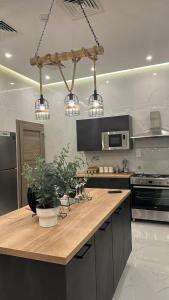 a kitchen with a wooden counter top with lights at The calm Zone 