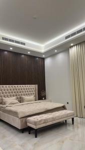 a bedroom with a large bed with a tufted headboard at The calm Zone 