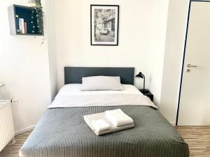 a bedroom with a bed with two towels on it at 21qm² Business Apartment in Bielefeld