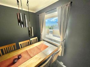 a dining room with a table and a window at House in the heart of Lofoten with spectacular view in Reine