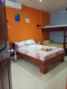 a bedroom with two beds and a bunk bed at Surfari Bocas in Bocas Town