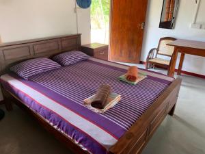 a bedroom with a bed with towels and a table at Sahana Retreat in Buttala