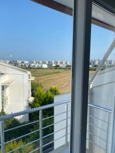 a balcony with a view of the city at Denize 800 m uzaklıkta villamız in Aksu