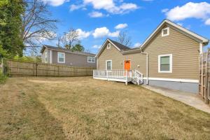 a house with a fence in front of a yard at 20% off! Spacious 4BR House w/ Free Parking, Wi-Fi in Atlanta