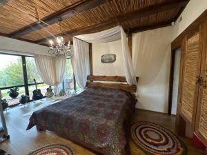 a bedroom with a bed and a chandelier at Chervona Kalyna Cottage in Odesa