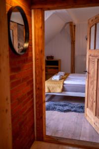 a bedroom with a bed and a mirror and a door at Apartamenty Sudeckie nad zalewem II in Sosnówka