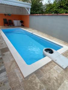 a swimming pool with a bench in the middle of it at Villa Norah t5 duplex in Le Robert