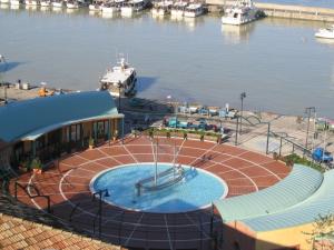 a swimming pool next to a marina with boats at Residence Darsena in Cattolica