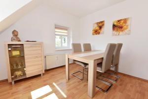 a dining room with a wooden table and chairs at Ferienwohnung Harmony in Leisnig