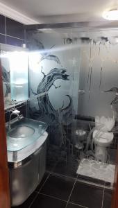 a bathroom with a sink and a dragon mural on the wall at Riverfront Retreat Prime Location Apartment with Stunning Views of the RioNegro in Manaus