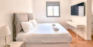 En eller flere senge i et værelse på BnBIsrael Apartments - Hakovshim Marguerite