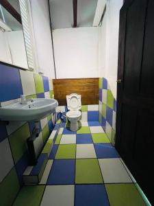 a bathroom with a sink and a toilet at TheLakeHostel in Hikkaduwa