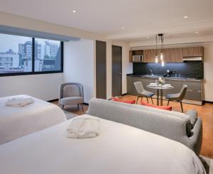 a hotel room with two beds and a kitchen at Amberes 64 in Mexico City