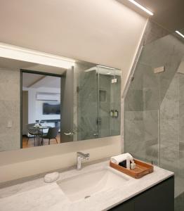a bathroom with a sink and a glass shower at Amberes 64 in Mexico City