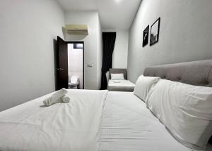 a white bed with a stuffed animal on top of it at Queen’s Villa for 28Pax @Central of Penang in Jelutong