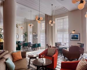 a living room with couches and tables and chairs at Fera Palace Hotel in Salvador