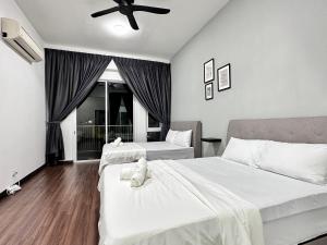 a bedroom with two beds and a ceiling fan at Queen’s Villa for 28Pax @Central of Penang in Jelutong