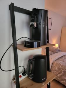 a coffee maker on a shelf next to a bed at Studio proche gare Vernon Giverny avec parking gratuit in Vernon