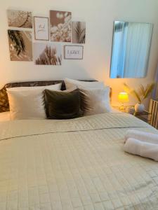 a bedroom with a large white bed with pillows at Ferienwohnung Paula in Bad Harzburg +37 photos