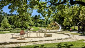 einen Spielplatz mit Rutsche in einem Park in der Unterkunft Kleine Freiheit App am See in Hahnenklee-Bockswiese