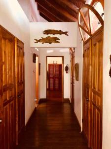 a hallway of a house with wooden floors and doors at Parrot Estate Villa in Englishmanʼs Bay