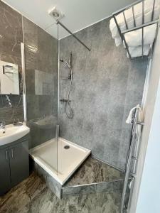 a bathroom with a shower and a sink at Bay Court in Llandudno