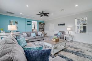 a living room with couches and a ceiling fan at Sparrow's Nest in Rockport