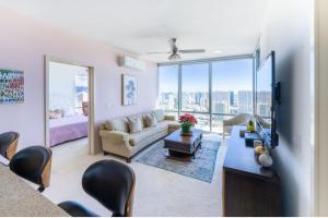 a living room with a couch and a tv at Luxury Residence at Kakaako in Honolulu