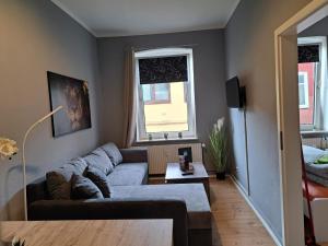 a living room with a couch and a table at Flensburg City 10 1 OG L in Flensburg