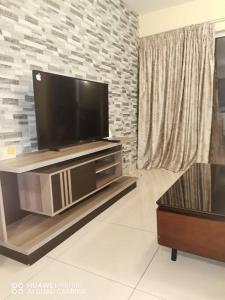 a living room with a flat screen tv on a entertainment center at Oliphant luxurious in Durban