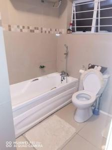 a bathroom with a toilet and a bath tub and a toilet at Oliphant luxurious in Durban