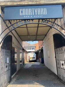 a building with a sign that reads community garage andvenue at Beautiful 1 Bedroom Maisonette in Leicester