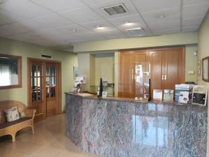 a lobby with a large marble counter in a room at Hotel Dora in Plasencia