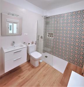 a bathroom with a toilet and a sink and a shower at Apartamentos Pepita in San Sebastián de la Gomera