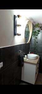 a bathroom with a sink and a mirror at Home From Home in Teguise