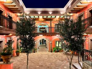 a hallway in a building with two trees in it at Concepción Hotel Boutique - Adults Only in San Miguel de Allende