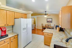 a kitchen with a white refrigerator and a dining room at Pet-Friendly Arizona Abode Near Beaches and Golfing! in Lake Havasu City