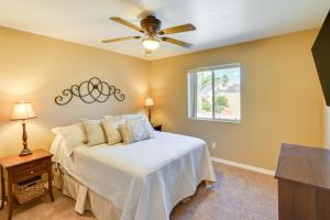a bedroom with a bed with a ceiling fan at Pet-Friendly Arizona Abode Near Beaches and Golfing! in Lake Havasu City
