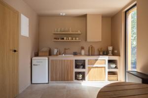 a kitchen with a white refrigerator and a sink at Casa Bonita Niechorze in Niechorze
