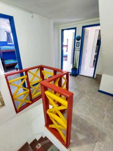 a staircase in a room with yellow and blue at Mundo da Lua Hostel in Morro de São Paulo +24 photos