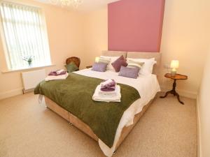 a bedroom with a large bed with towels on it at 195 Durham Road in Consett